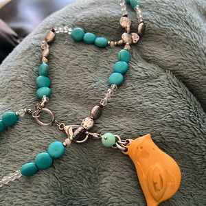 #27.  Turquoise Colored Necklace With Yellow Bird *distressed*